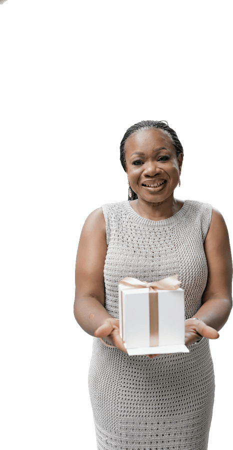 Anne, smiling, holding out a small wrapped gift